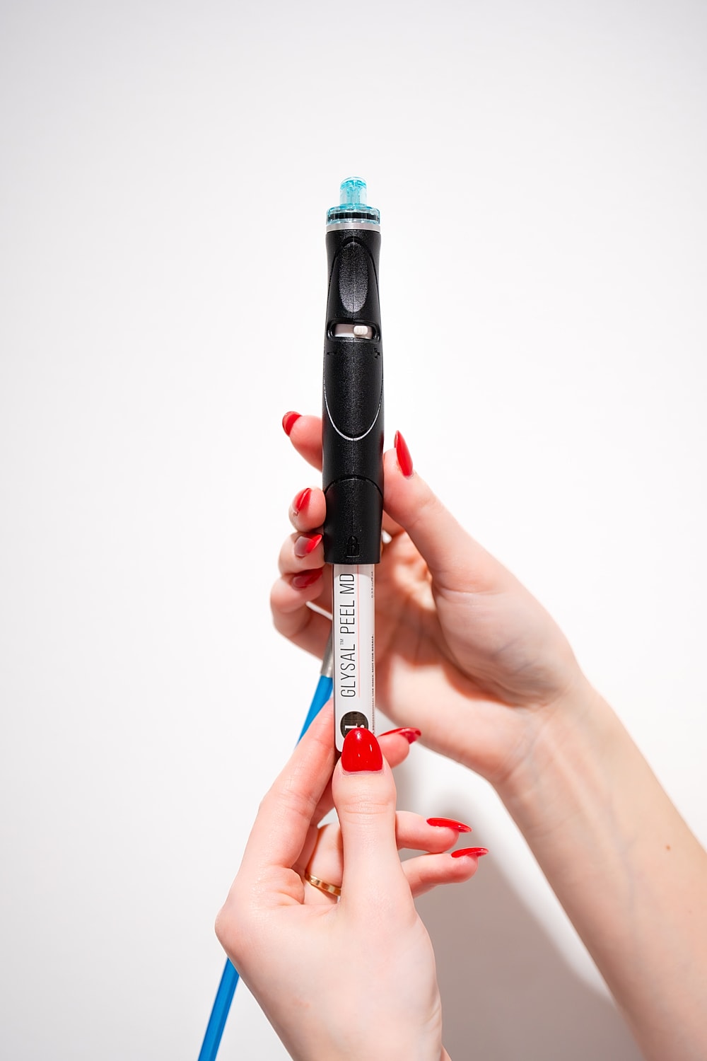 Woman examining lips in mirror at clinic.