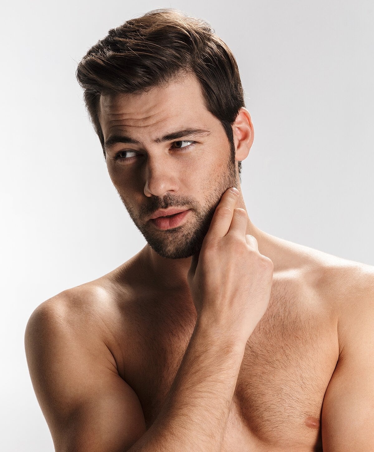 Woman examining lips in mirror at clinic.