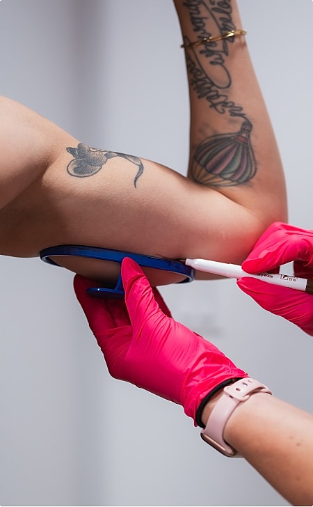 Woman examining lips in mirror at clinic.