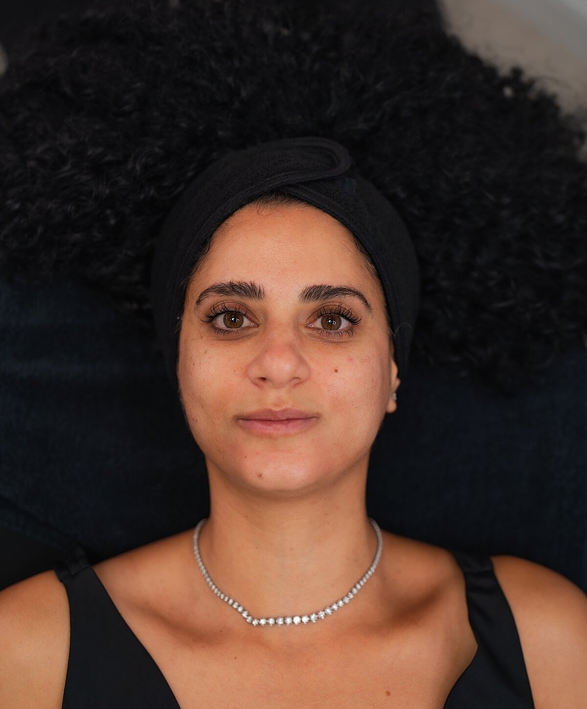 Client enjoying a beauty treatment at salon.