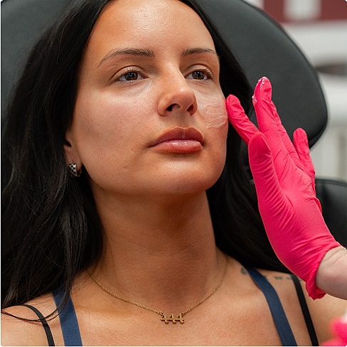 Woman receiving facial treatment in a clinic.