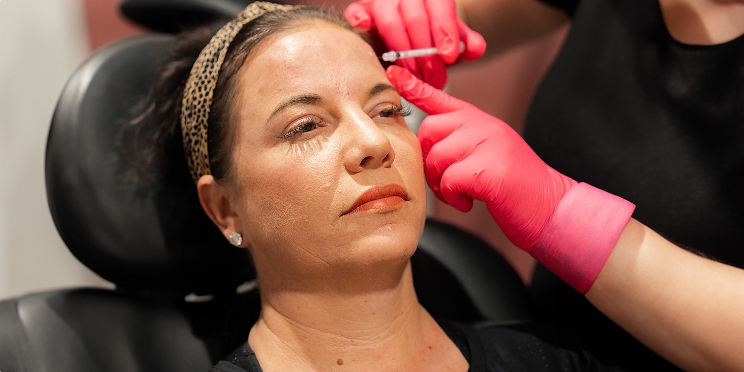 Woman receiving cosmetic treatment in beauty clinic.