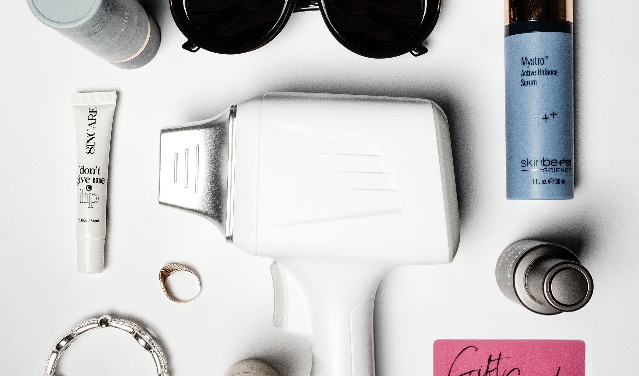 Skin care products and accessories flat lay arrangement.