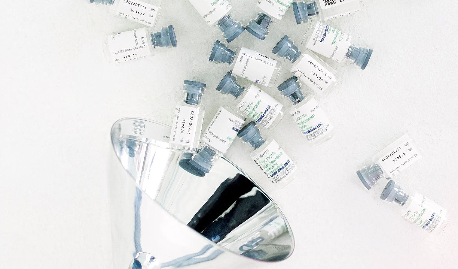 Vials and tools for cosmetic procedures on table.